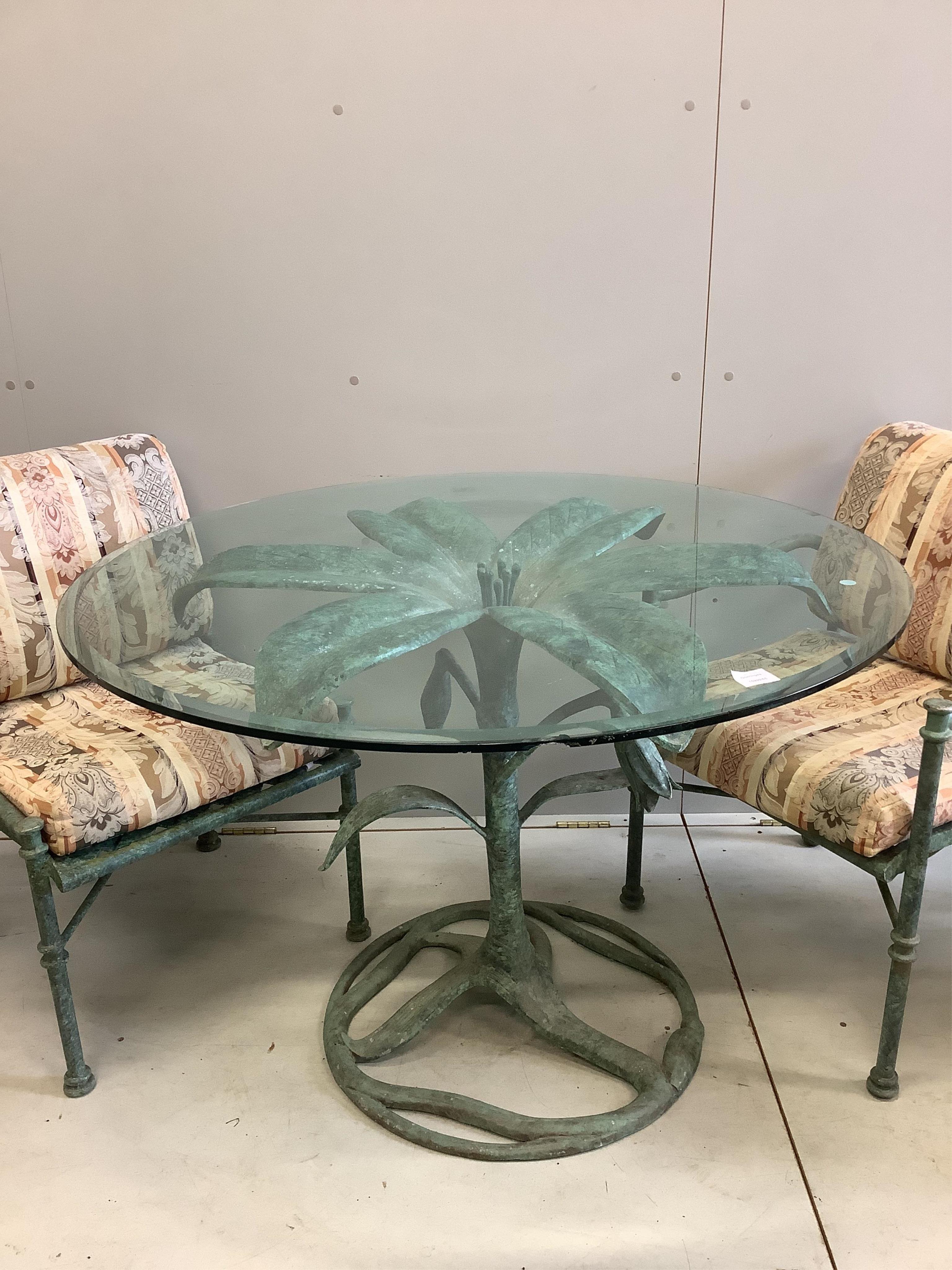 A green patinated iron palm tree design glass topped conservatory table, diameter 106cm, height 74cm and four matching armchairs with cushion seats and backs. Condition - fair to good